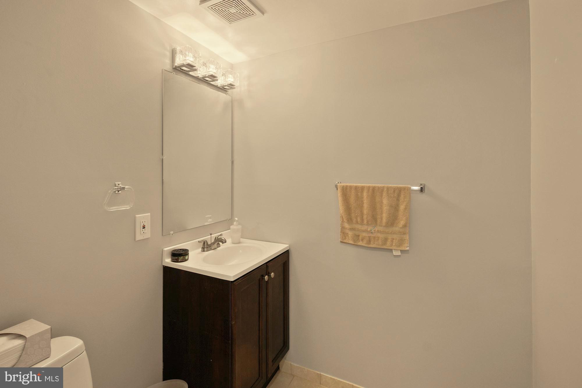 9122 Centerway Road Gaithersburg, MD 20879 - Photo 25 of 33 a bathroom with a sink and a mirror