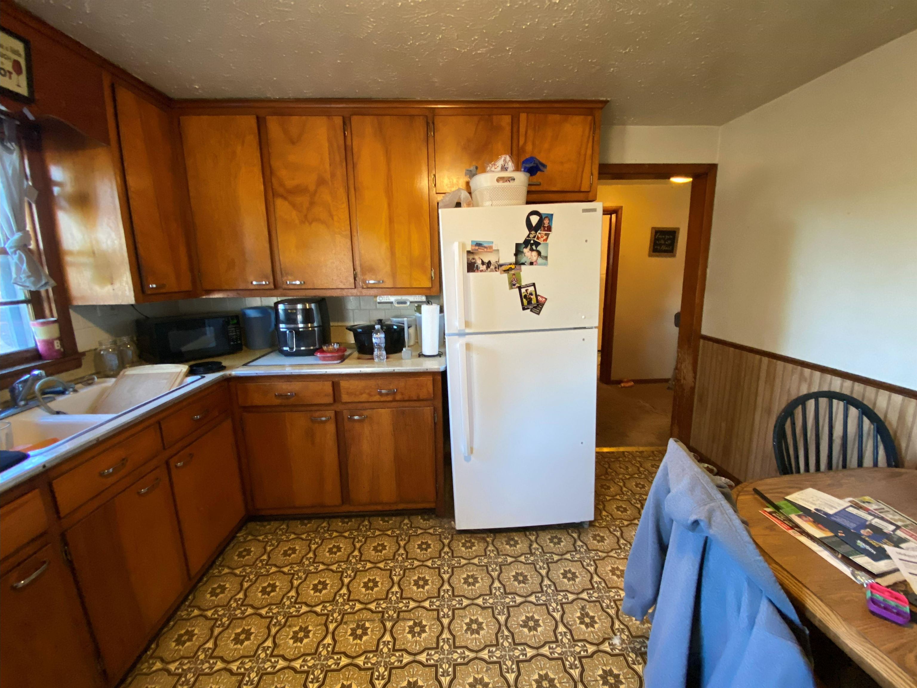 611 West Locust Street Belvidere, IL 61008 - Photo 26 of 39 a kitchen with sink a refrigerator and cabinets