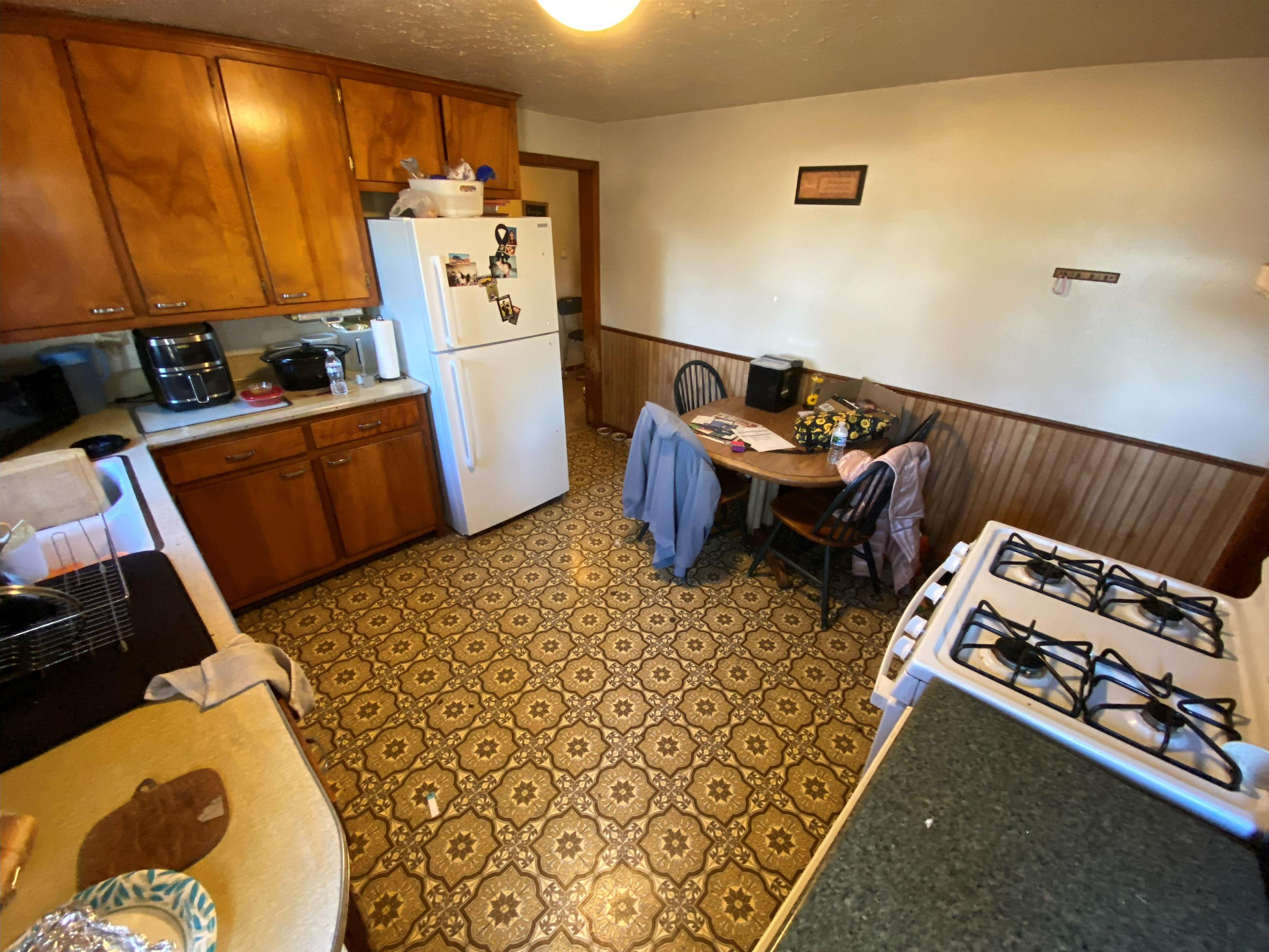 611 West Locust Street Belvidere, IL 61008 - Photo 27 of 39 a kitchen with a refrigerator and a stove
