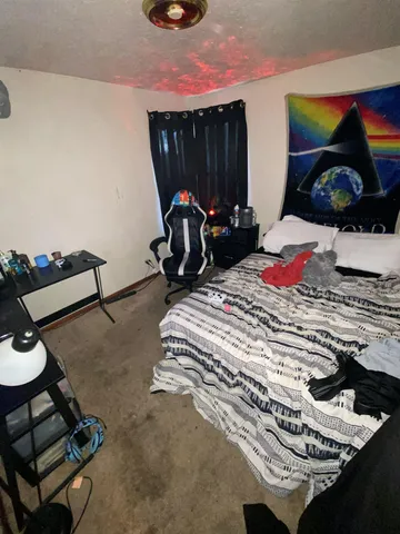 a bedroom with a bed and a window