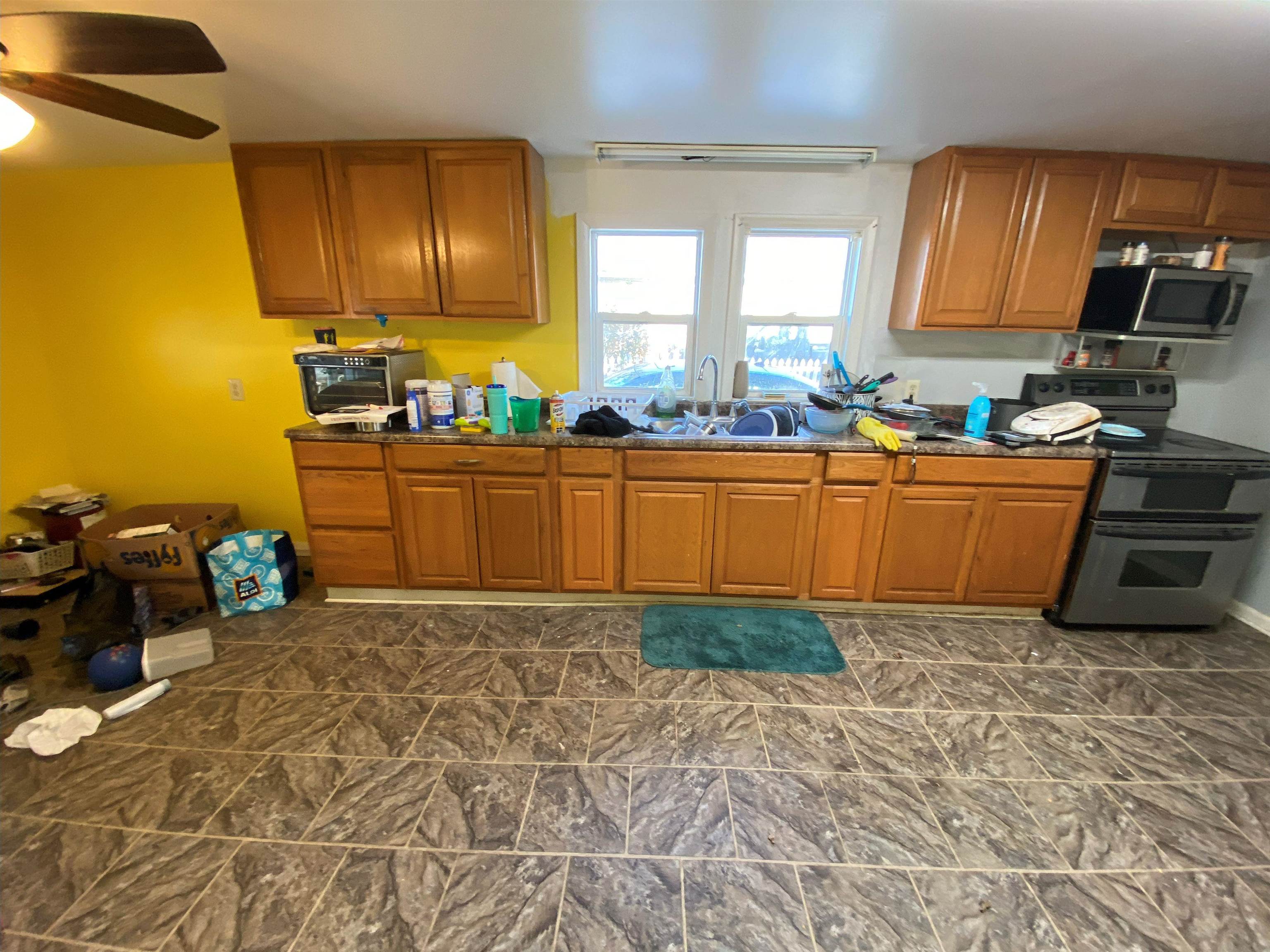 611 West Locust Street Belvidere, IL 61008 - Photo 5 of 39 a kitchen with granite countertop a stove a sink and a wooden cabinets