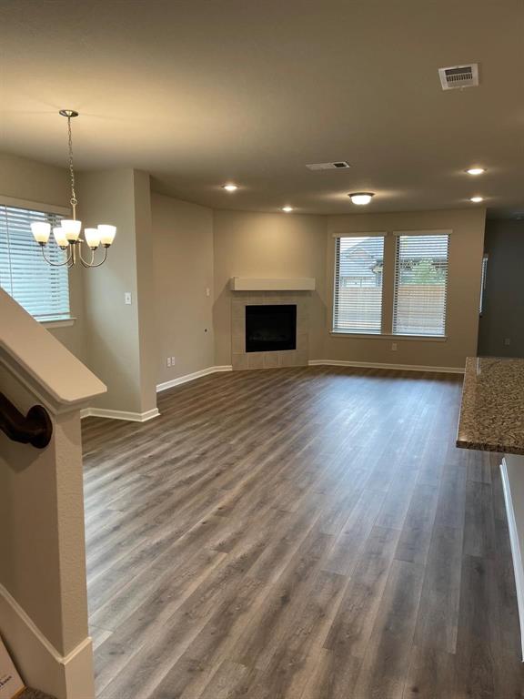 5529 Blue Point Lane Garland, TX 75043 - Photo 4 of 15 a view of a room with wooden floor and a fireplace