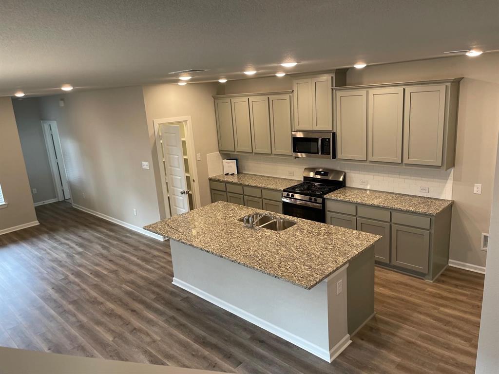 5529 Blue Point Lane Garland, TX 75043 - Photo 6 of 15 a kitchen with a sink stove and refrigerator