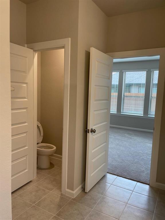 5529 Blue Point Lane Garland, TX 75043 - Photo 7 of 15 a bathroom with a toilet and a shower