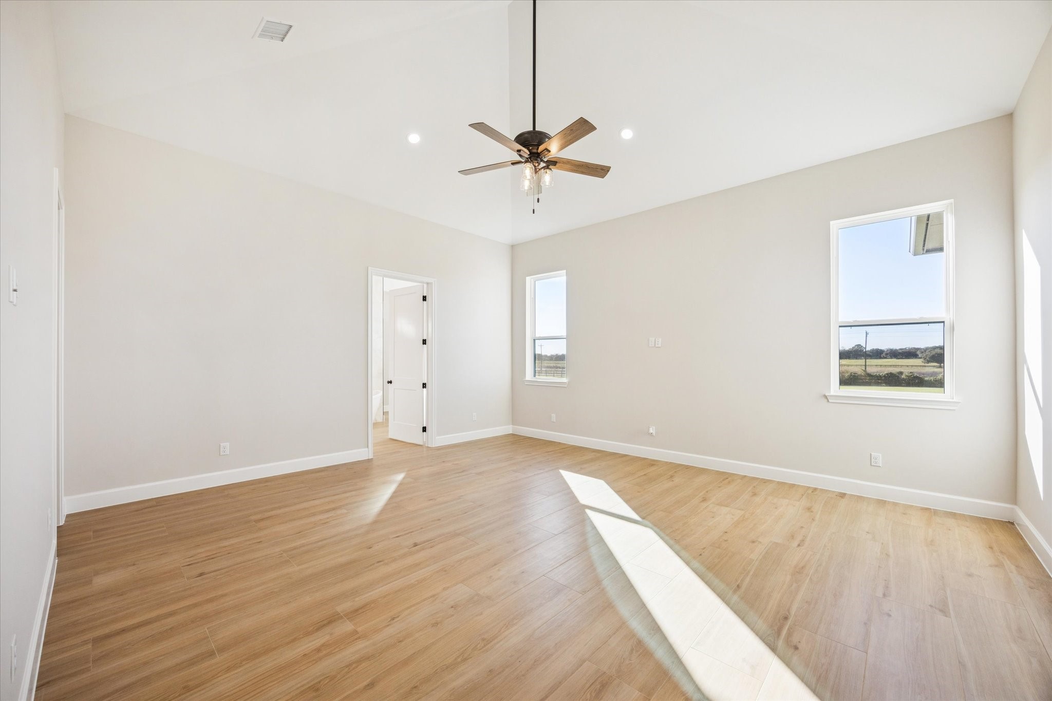 27645 Spring Hill Road Hempstead, TX 77445 - Photo 14 of 32 an empty room with a ceiling fan and wooden floor