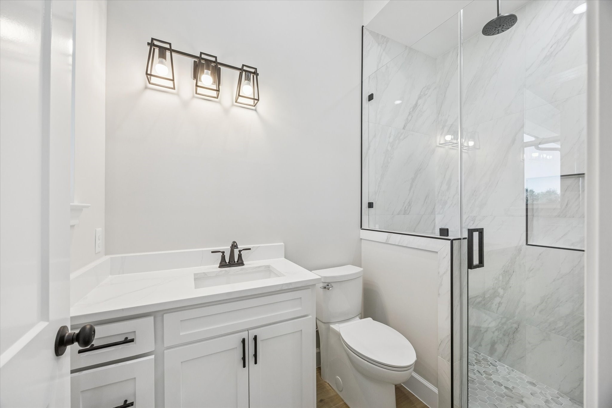 27645 Spring Hill Road Hempstead, TX 77445 - Photo 21 of 32 a bathroom with a toilet a sink a mirror and vanity