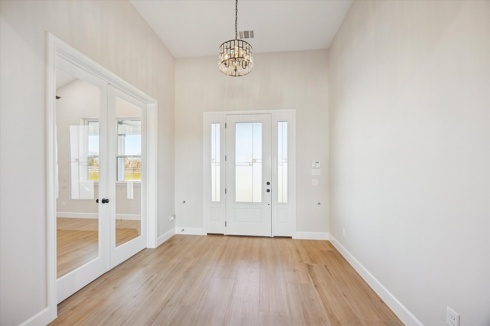 27645 Spring Hill Road Hempstead, TX 77445 - Photo 4 of 32 a view of an empty room with wooden floor and a window