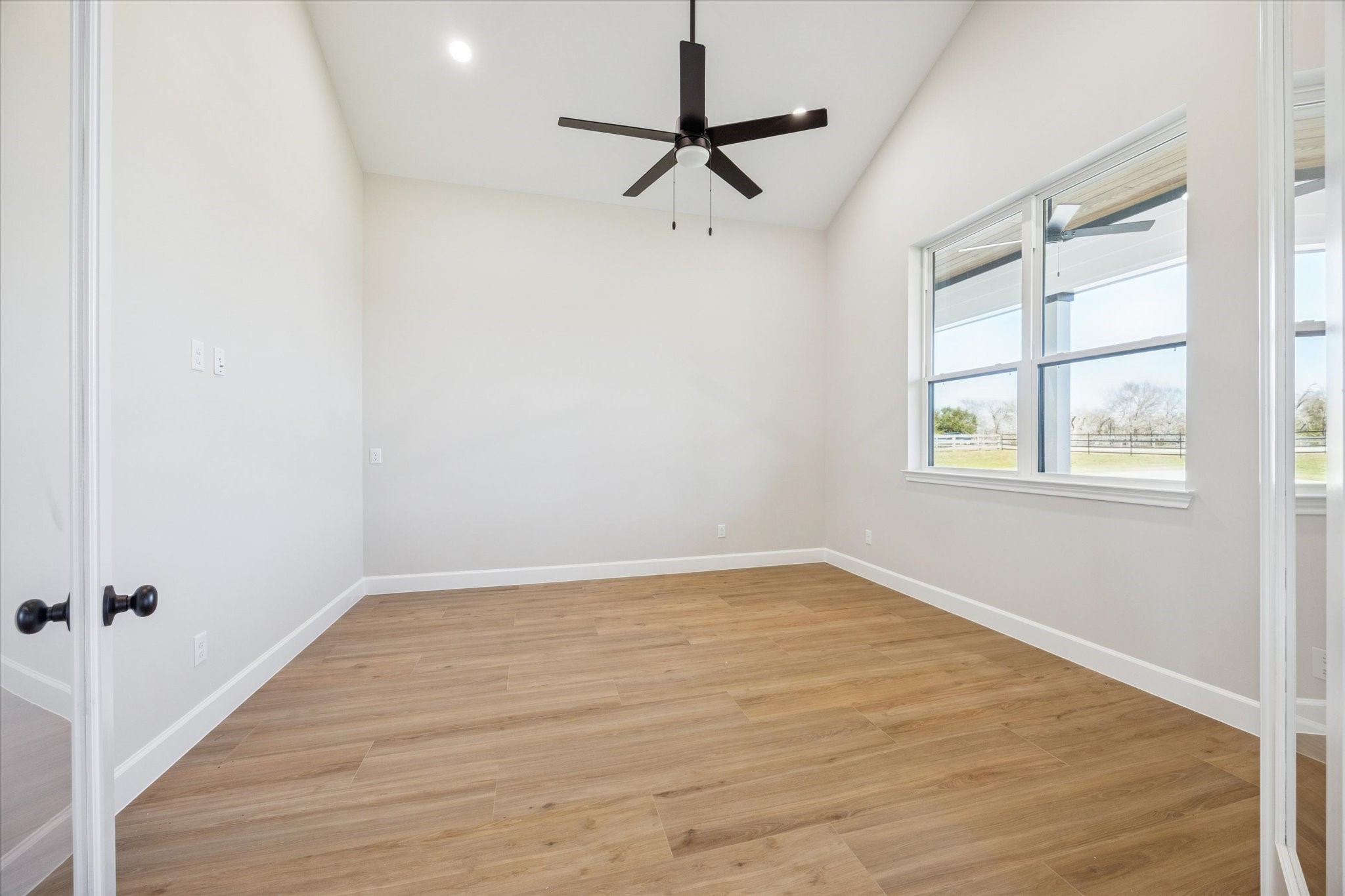 27645 Spring Hill Road Hempstead, TX 77445 - Photo 5 of 32 an empty room with a window and a fan