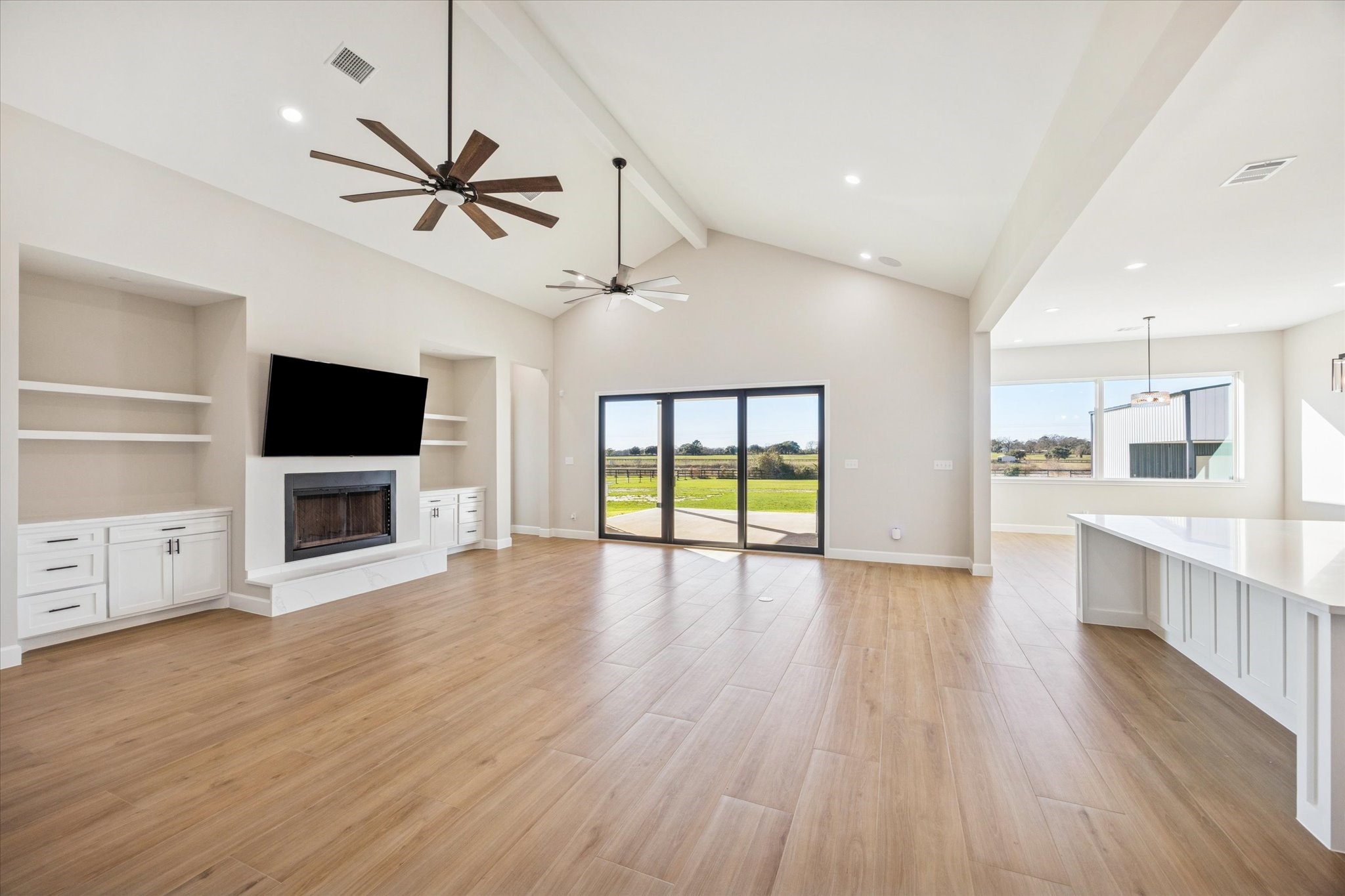 27645 Spring Hill Road Hempstead, TX 77445 - Photo 6 of 32 a view of a kitchen with furniture a ceiling fan and wooden floor