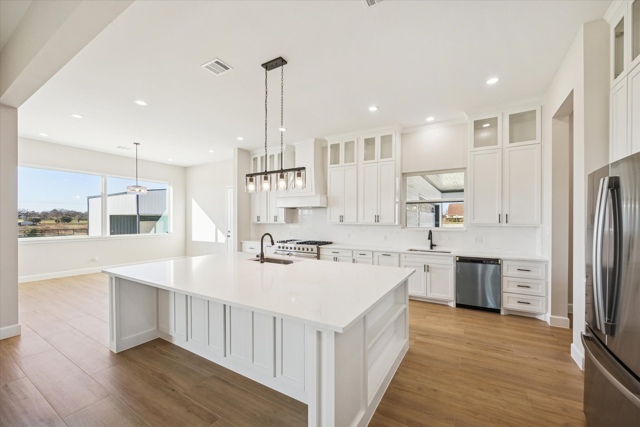 27645 Spring Hill Road Hempstead, TX 77445 - Photo 9 of 32 a large kitchen with stainless steel appliances lots of counter space and wooden floor
