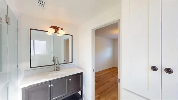 a bathroom with a double vanity sink and mirror