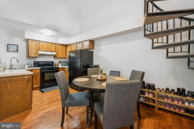 a dining room with furniture and wooden floor