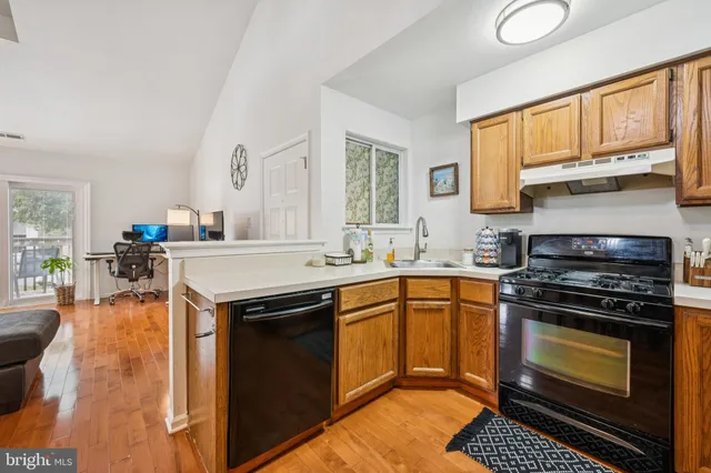 a kitchen with a stove sink and cabinets