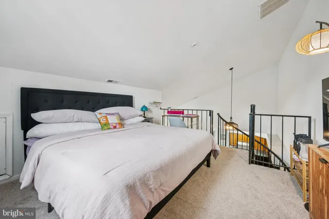 a bedroom with bed and a chandelier