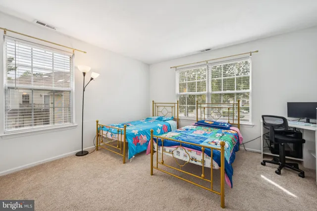 a bedroom with a bed and a desk