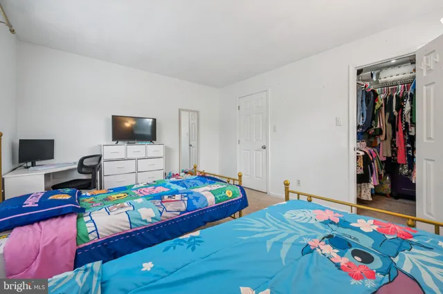 a bedroom with bed and a tv