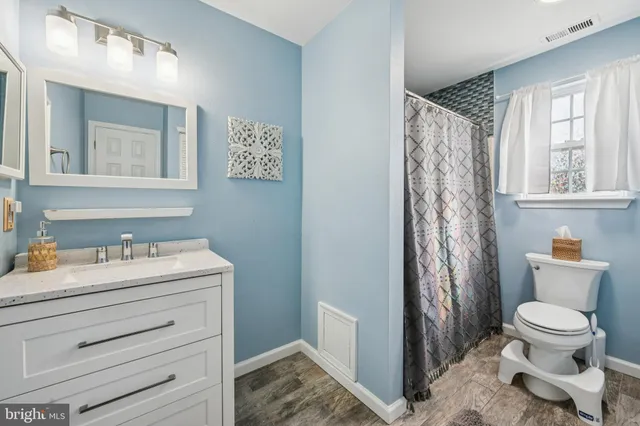 a bathroom with a toilet sink and mirror