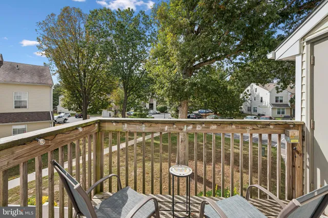a view of balcony with wooden floor and fence