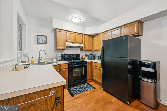 a kitchen with a refrigerator sink and stainless steel appliances