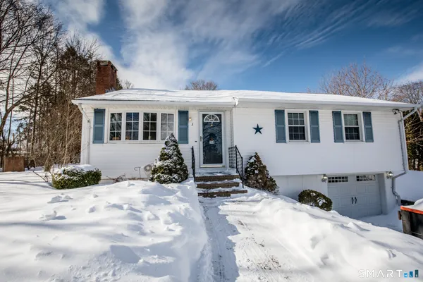 a view of a house with snow in the yard