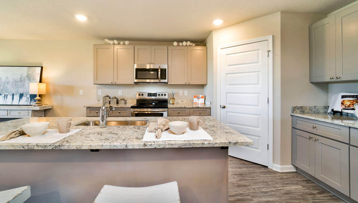 30 Fannin Street Freeport, FL 32439 - Photo 6 of 16 a kitchen with stainless steel appliances granite countertop a sink a stove and cabinets