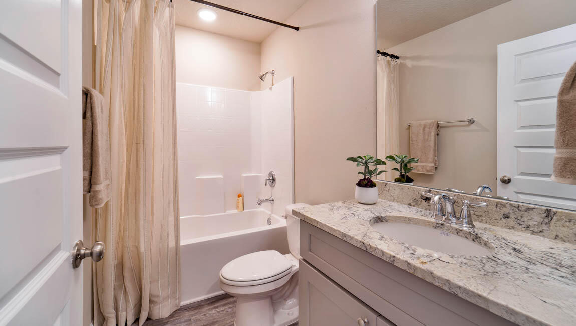 30 Fannin Street Freeport, FL 32439 - Photo 9 of 16 a bathroom with a granite countertop sink toilet and shower