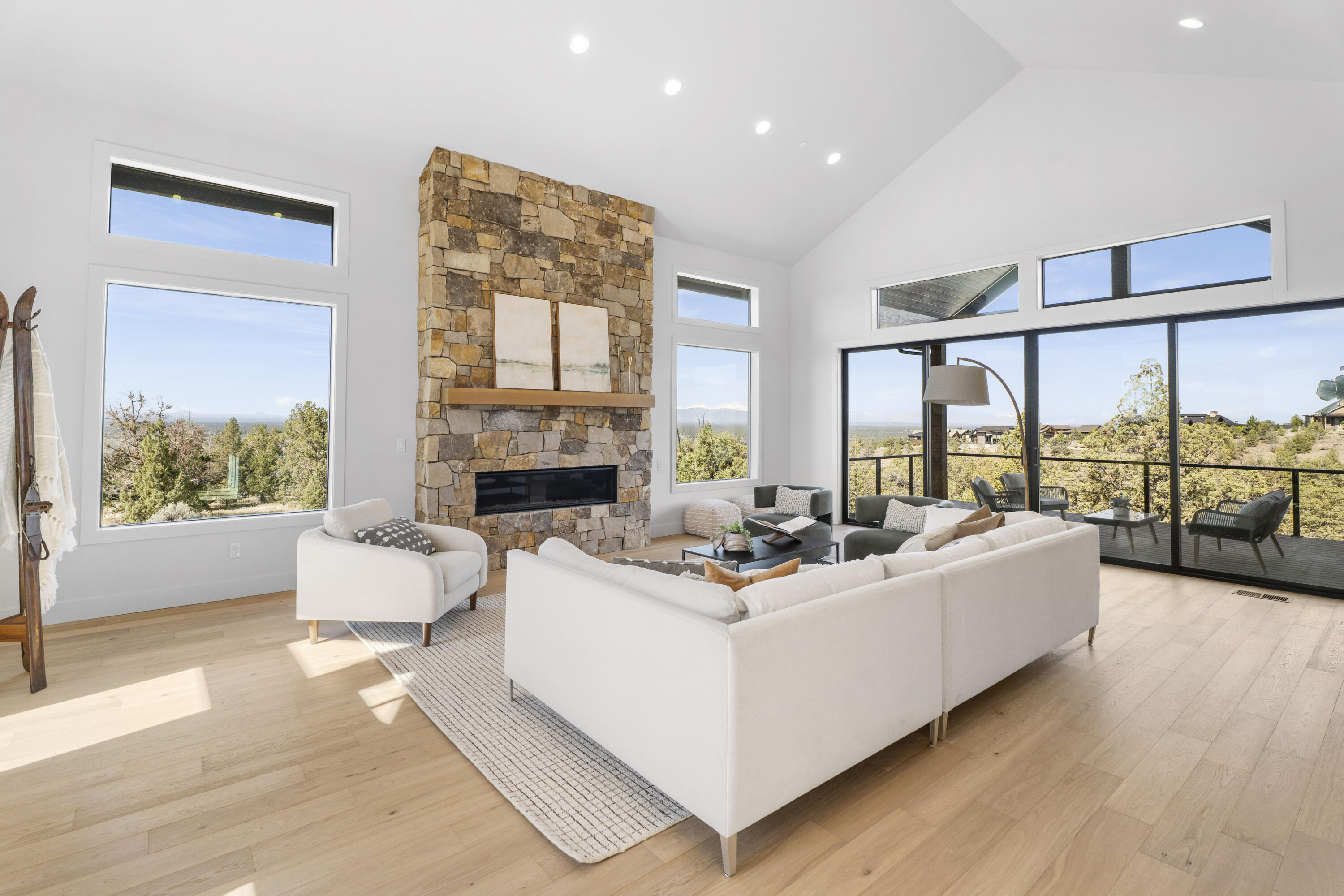 16883 Southwest Paragon Court Powell Butte, OR 97753 - Photo 4 of 42 Stone fireplace, vaulted ceilings, and numerous windows make the space bright and light