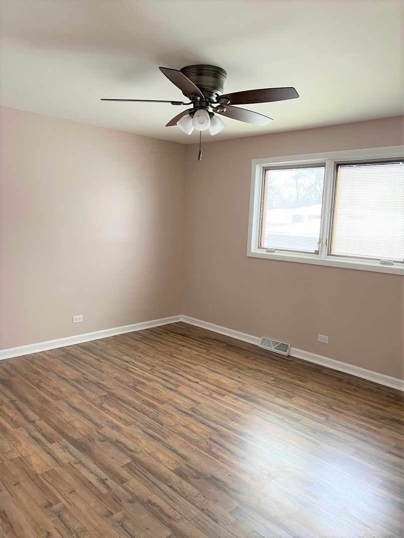 525 South Cherry Street Itasca, IL 60143 - Photo 11 of 20 wooden floor in an empty room with a window