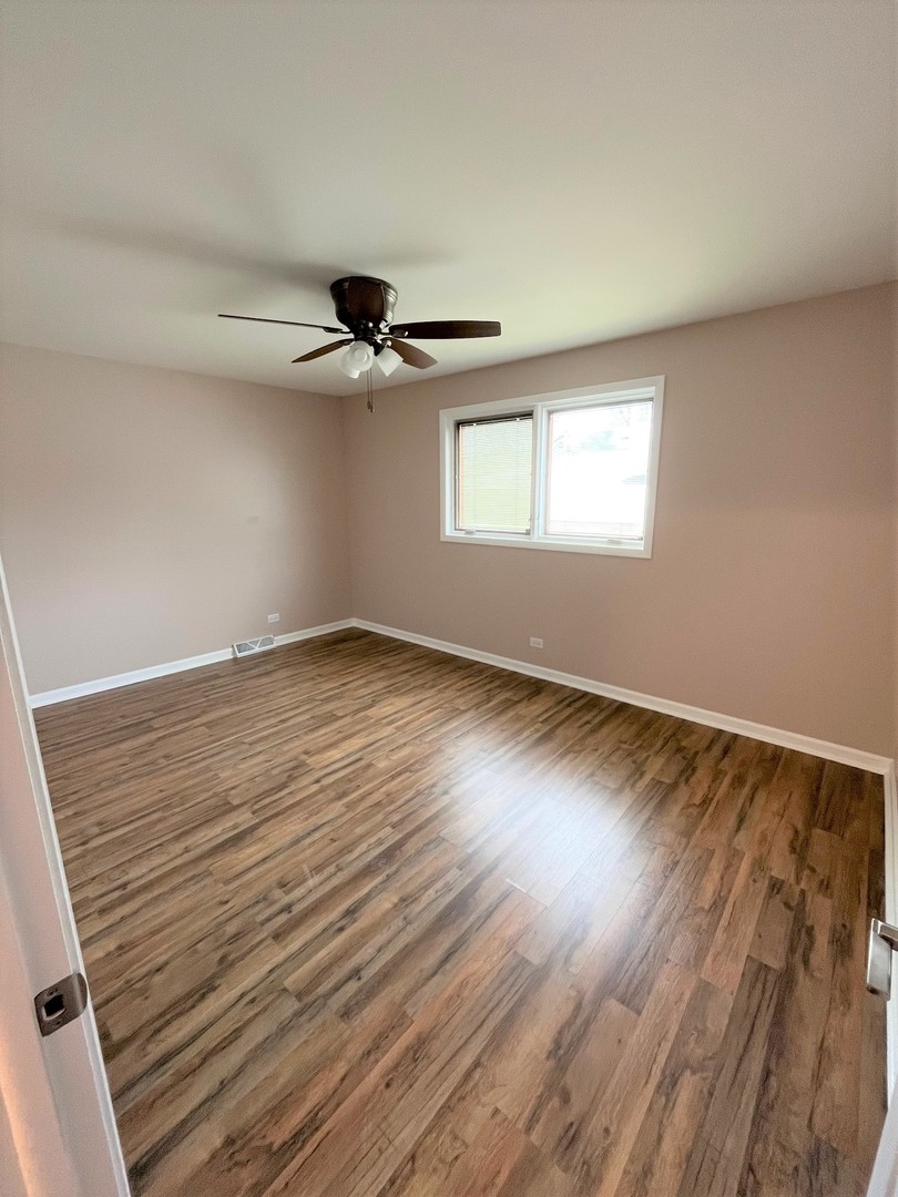 525 South Cherry Street Itasca, IL 60143 - Photo 13 of 20 wooden floor in an empty room with a window