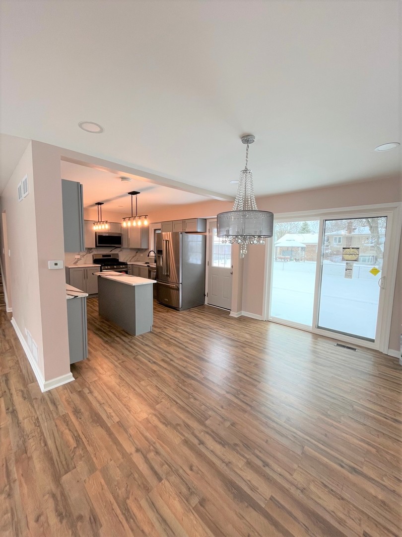 525 South Cherry Street Itasca, IL 60143 - Photo 6 of 20 a kitchen with stainless steel appliances wooden floor and large windows