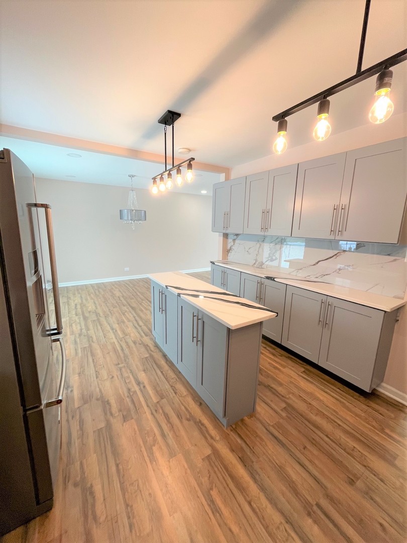 525 South Cherry Street Itasca, IL 60143 - Photo 7 of 20 a kitchen with a sink and wooden floor
