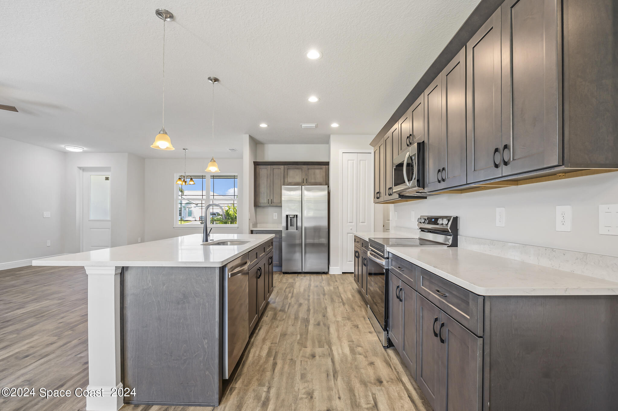 1368 Rabbit Street Southeast Palm Bay, FL 32909 - Photo 7 of 31 a kitchen with stainless steel appliances granite countertop a sink a stove and a refrigerator