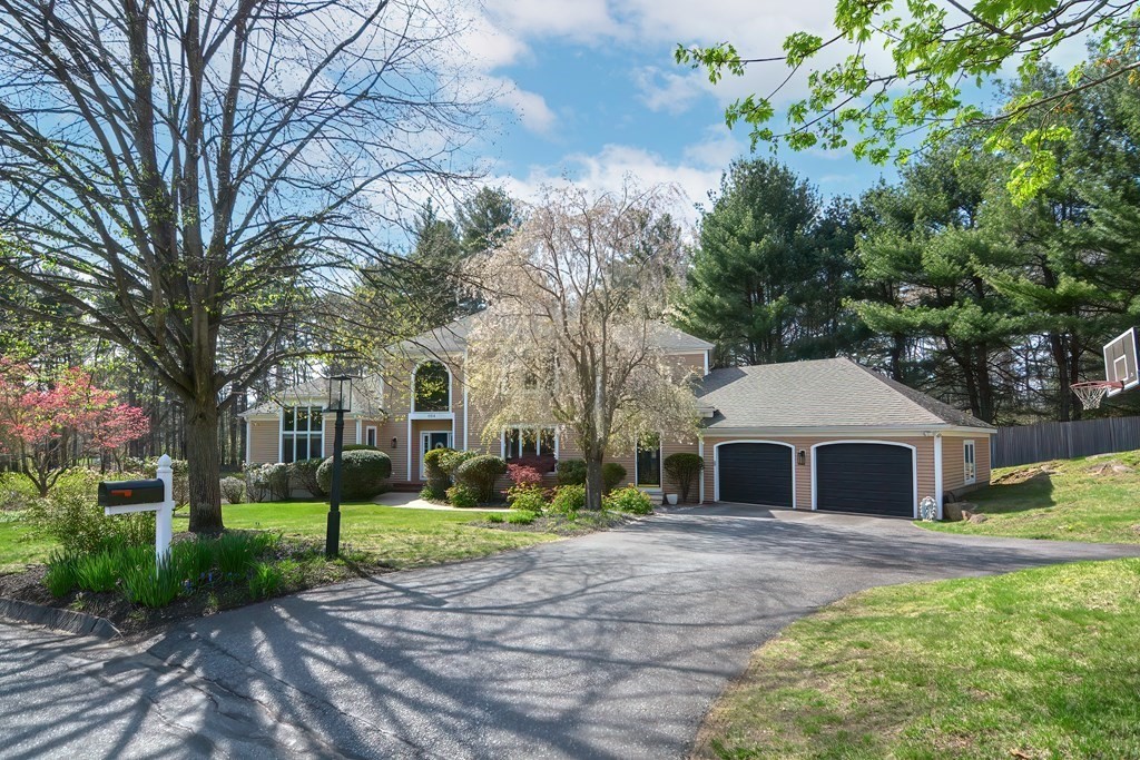 104 Channing Road Concord, MA 01742 - Photo 2 of 36 a front view of a house with garden and trees