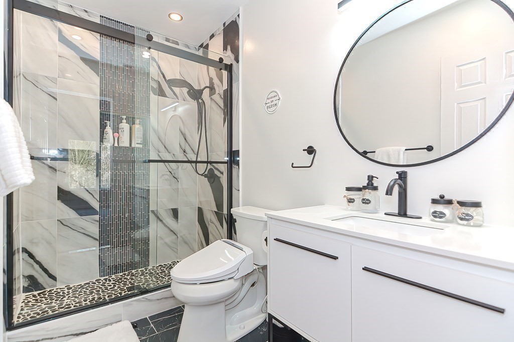 104 Channing Road Concord, MA 01742 - Photo 24 of 36 a bathroom with a sink a toilet and a mirror