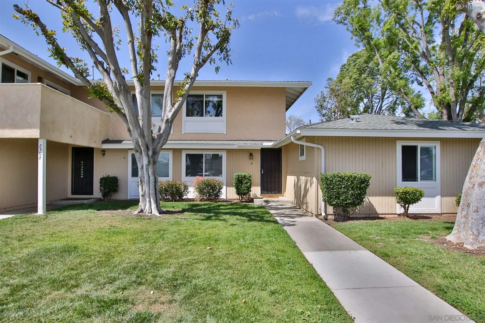 2502 Wanek Road, Unit B Escondido, CA 92027 - Photo 23 of 29 a front view of a house with a yard and trees