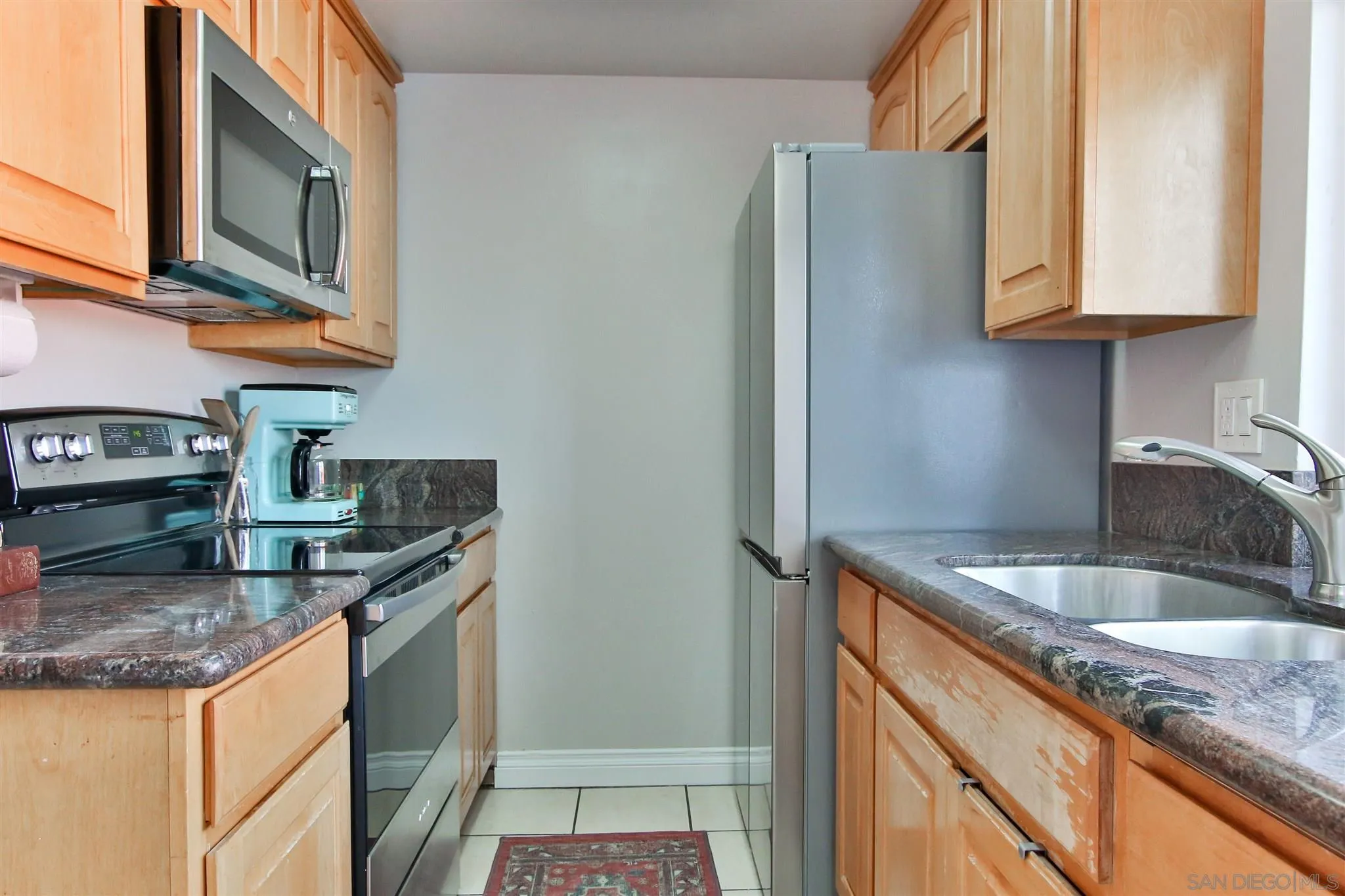 2502 Wanek Road, Unit B Escondido, CA 92027 - Photo 5 of 29 a kitchen with stainless steel appliances granite countertop a sink and a refrigerator