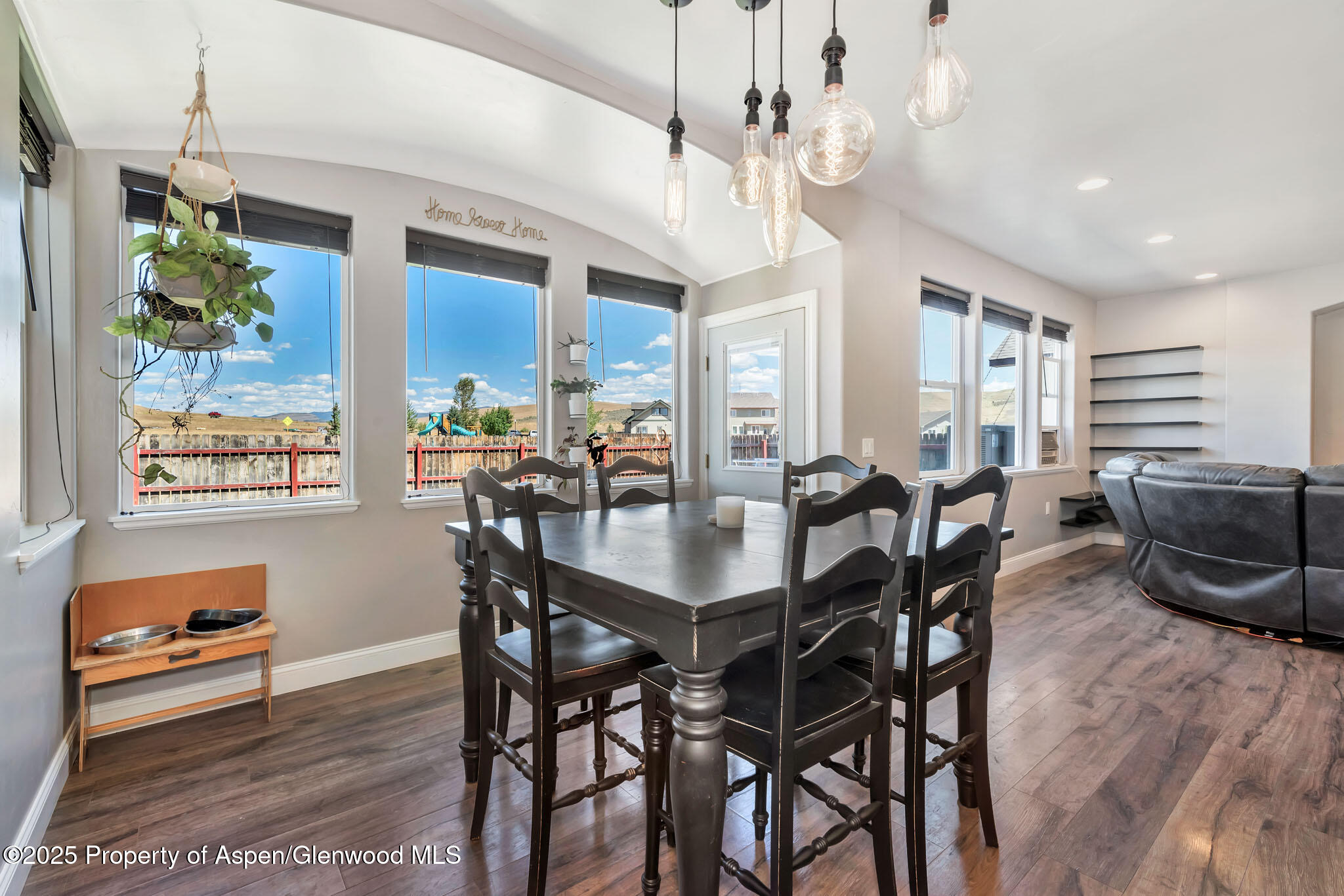 875 Dry Creek Road Hayden, CO 81639 - Photo 13 of 40 a view of a dining room with furniture a chandelier and wooden floor
