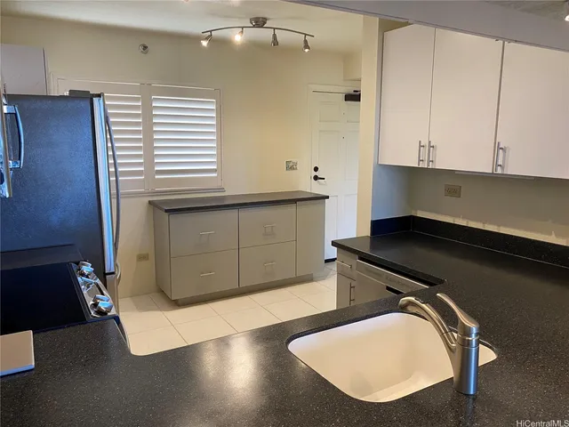 a kitchen with a sink and cabinets