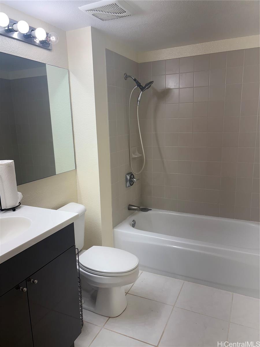 3075 Ala Poha Place, Unit 2111 Honolulu, HI 96818 - Photo 5 of 9 a bathroom with a toilet a sink and shower