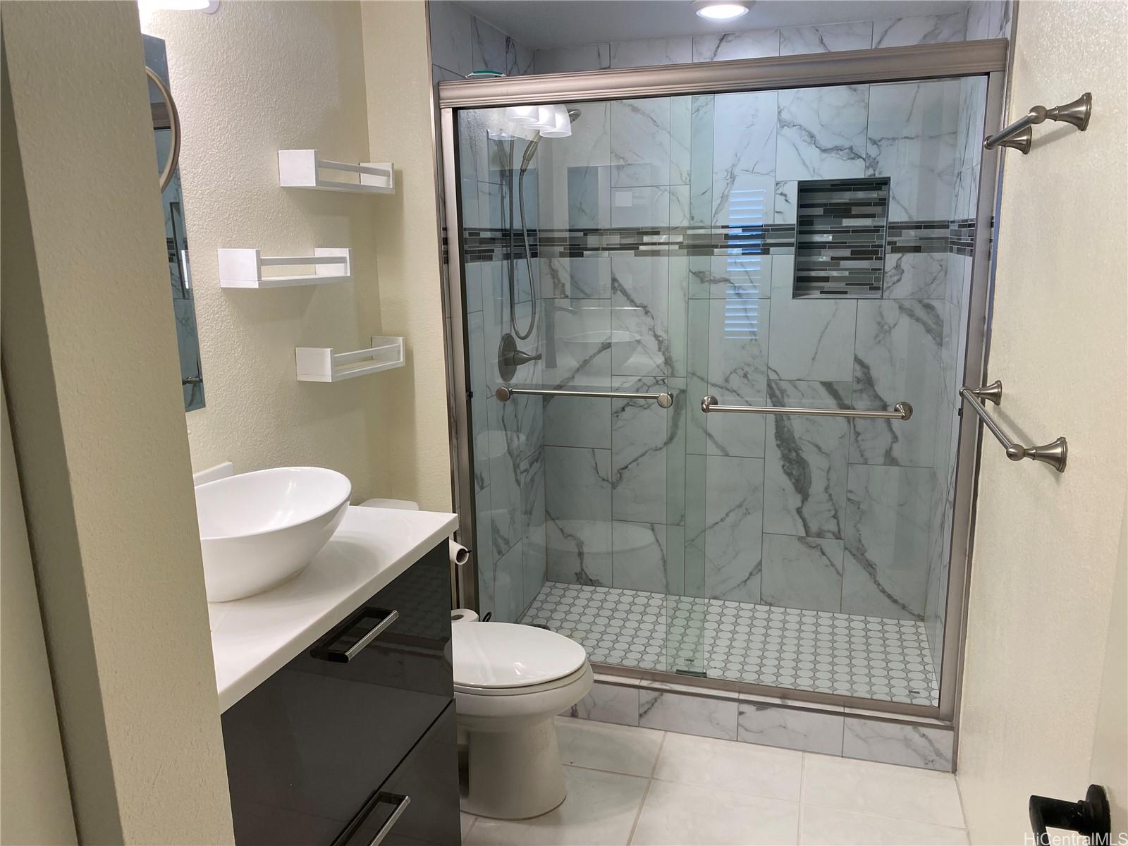 3075 Ala Poha Place, Unit 2111 Honolulu, HI 96818 - Photo 6 of 9 a bathroom with a shower a toilet and a sink
