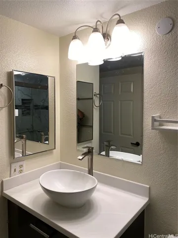 a bathroom with a sink a mirror and a shower