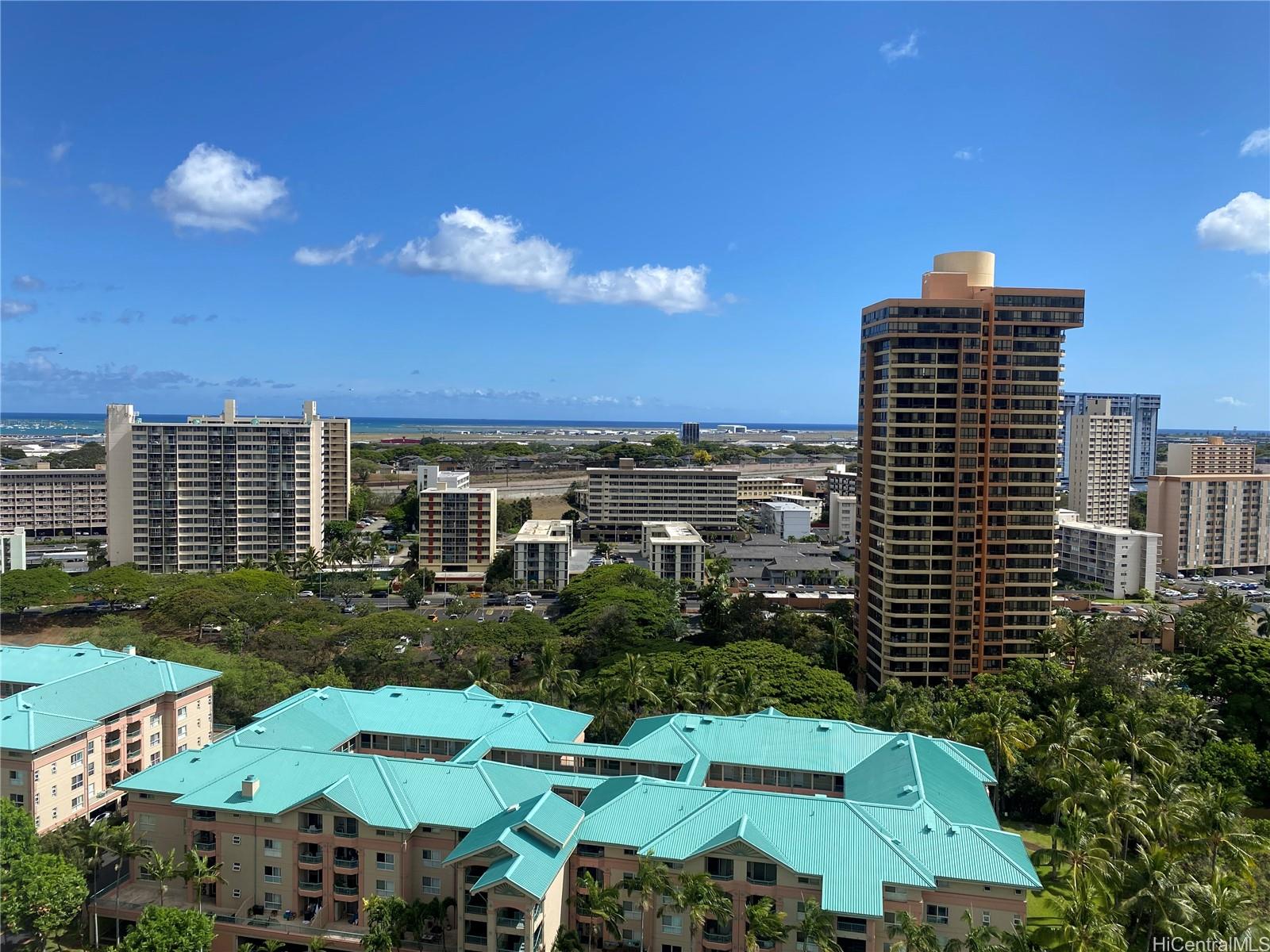 3075 Ala Poha Place, Unit 2111 Honolulu, HI 96818 - Photo 9 of 9 a view of a patio with lawn chairs potted plants and a big yard