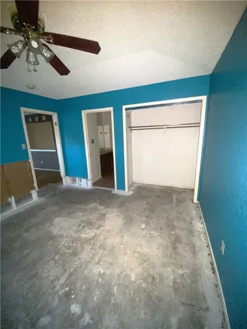 a view of empty room with ceiling fan