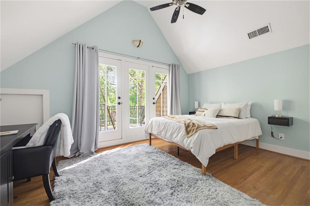 245 Forkner Drive Decatur, GA 30030 - Photo 19 of 31 a bedroom with a bed a flat screen tv and a large window