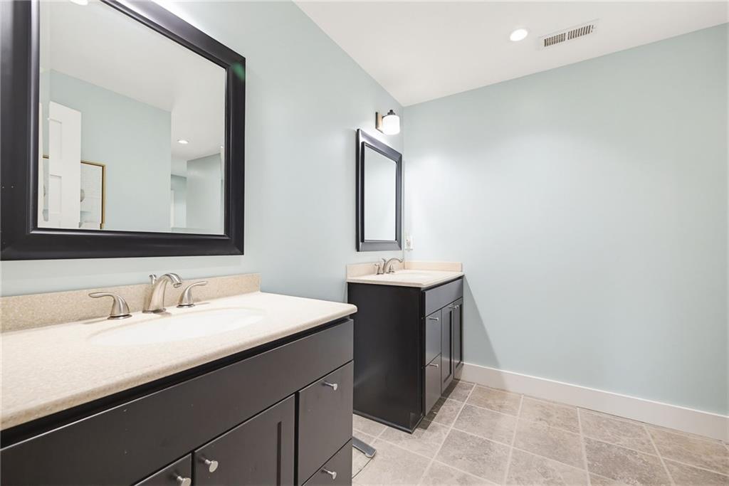245 Forkner Drive Decatur, GA 30030 - Photo 21 of 31 a bathroom with a sink and a mirror