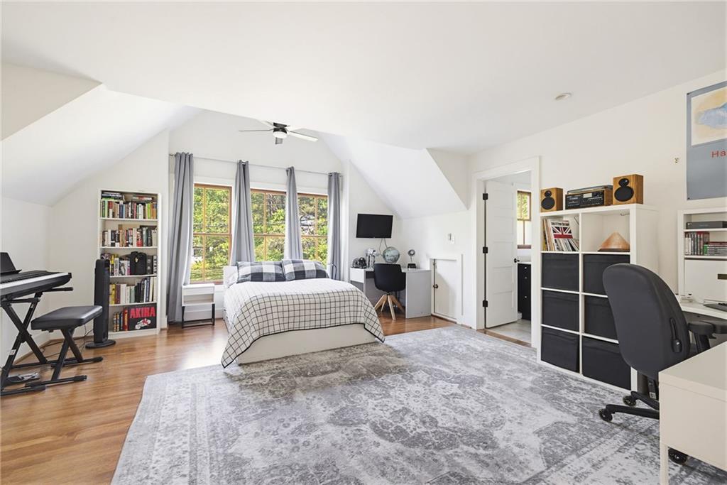 245 Forkner Drive Decatur, GA 30030 - Photo 23 of 31 a spacious bedroom with a bed and wooden floor