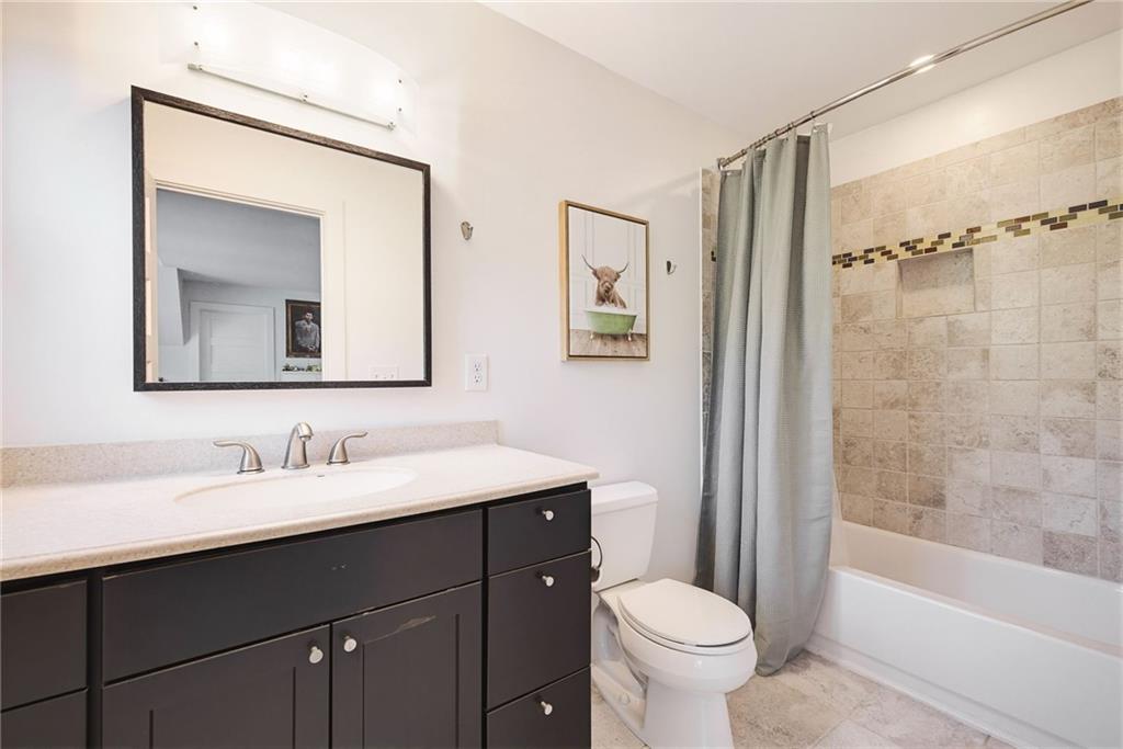 245 Forkner Drive Decatur, GA 30030 - Photo 24 of 31 a bathroom with a toilet sink and mirror