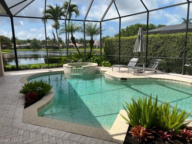 938 Spanish Moss Trail Naples, FL 34108 - Photo 6 of 11 a view of a swimming pool with a patio