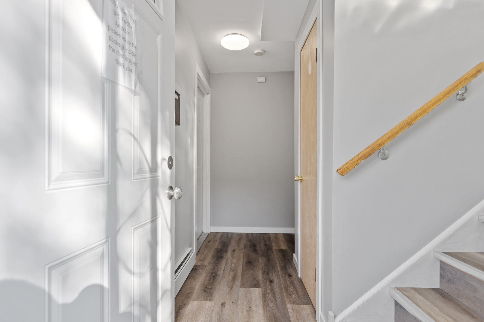 7535 Roberts Road Bridgeview, IL 60455 - Photo 2 of 30 a view of a hallway with wooden floor and staircase