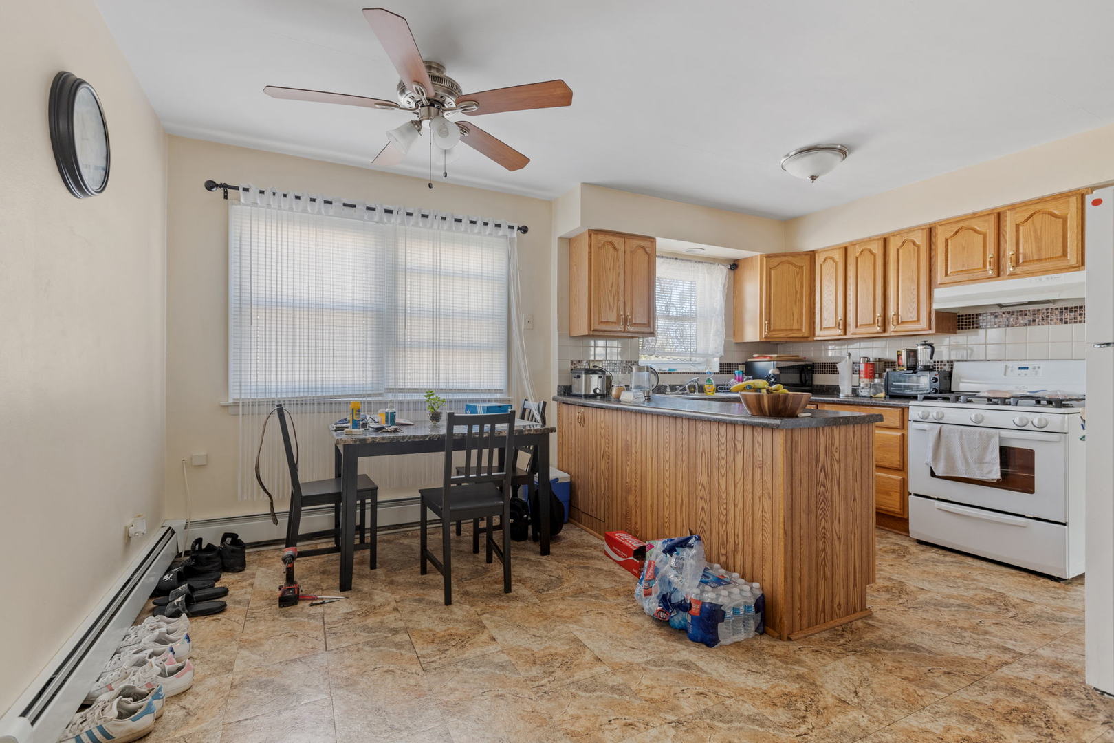 7535 Roberts Road Bridgeview, IL 60455 - Photo 16 of 30 a kitchen with granite countertop a stove a sink and a refrigerator
